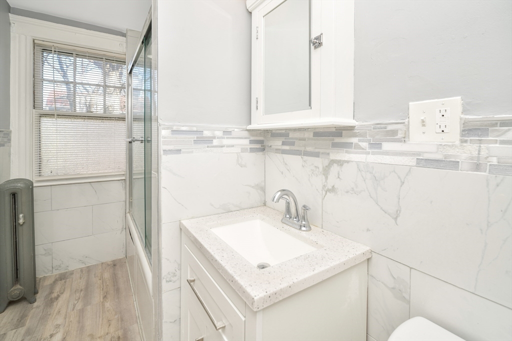 146 Homestead Street Boston, MA 02121 - Photo 21 of 40 a bathroom with a sink and a mirror