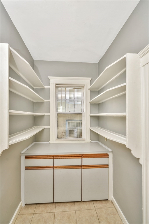 146 Homestead Street Boston, MA 02121 - Photo 24 of 40 a living room with a cabinet and a large window