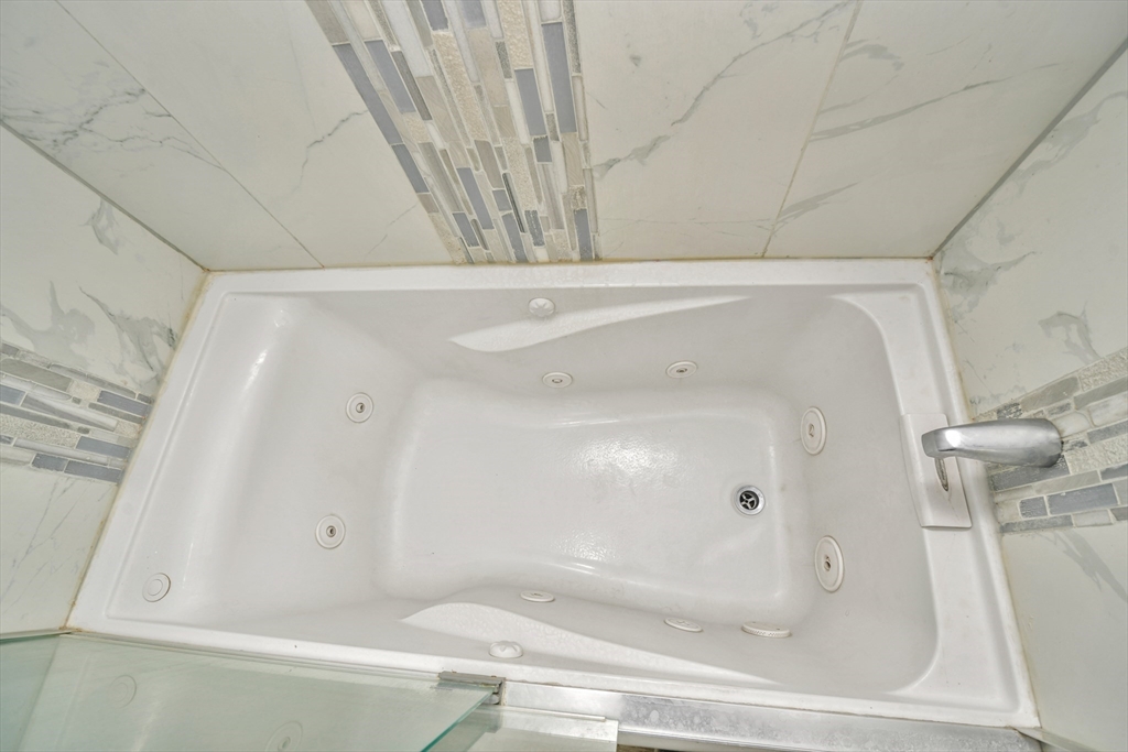 146 Homestead Street Boston, MA 02121 - Photo 30 of 40 a bathroom with a bathtub and shower