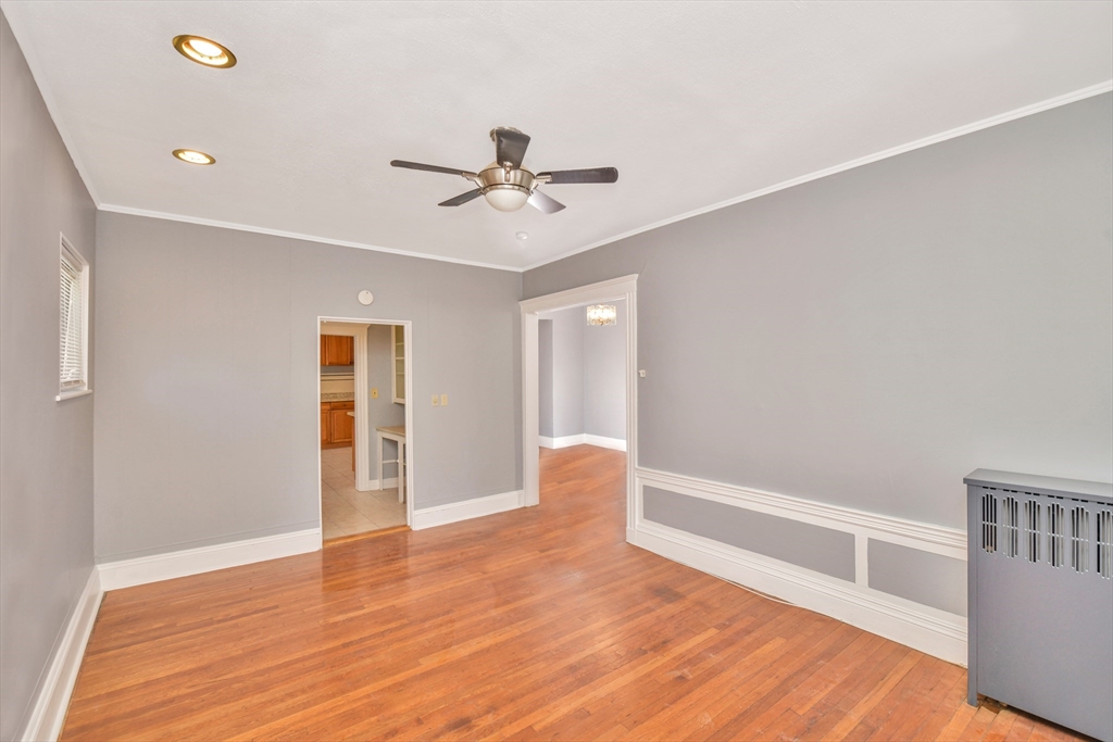 146 Homestead Street Boston, MA 02121 - Photo 3 of 40 a view of an empty room with a window and wooden floor