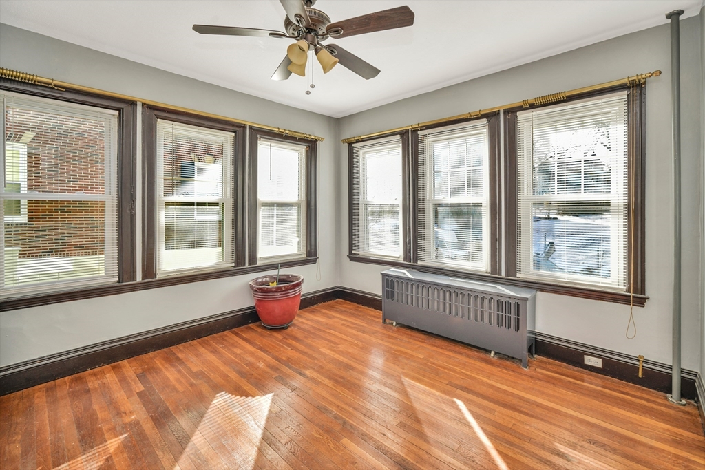 146 Homestead Street Boston, MA 02121 - Photo 31 of 40 a bedroom with furniture window and wooden floor