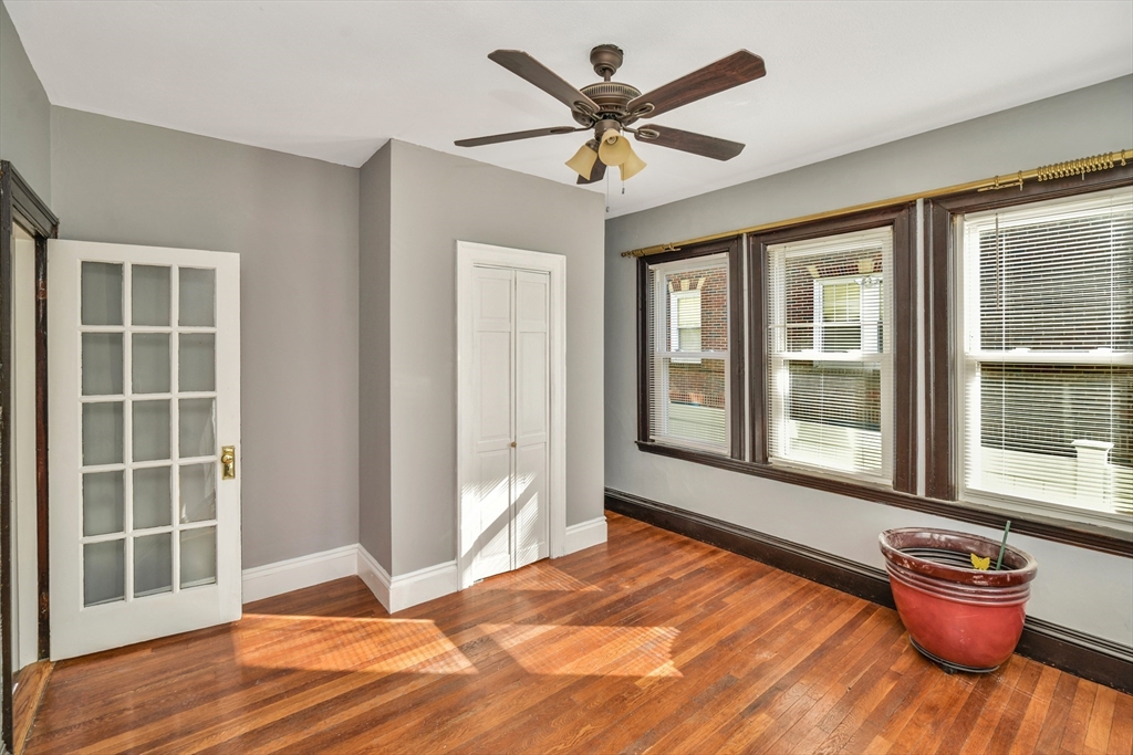 146 Homestead Street Boston, MA 02121 - Photo 32 of 40 a view of an empty room with a window and wooden floor
