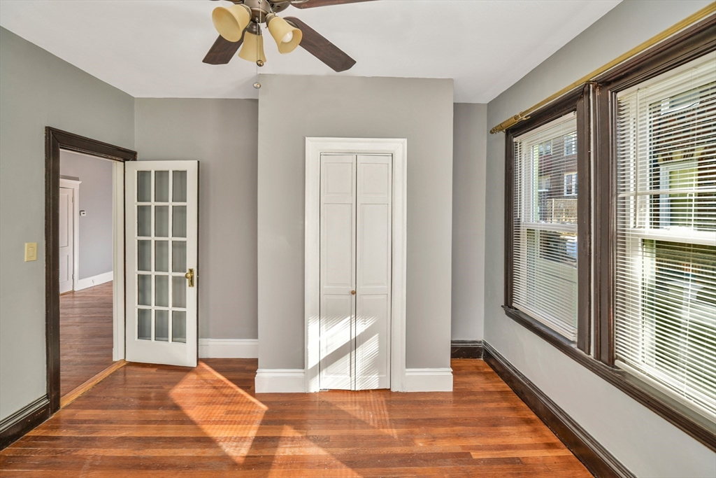 146 Homestead Street Boston, MA 02121 - Photo 33 of 40 a view of a livingroom with wooden floor and a ceiling fan