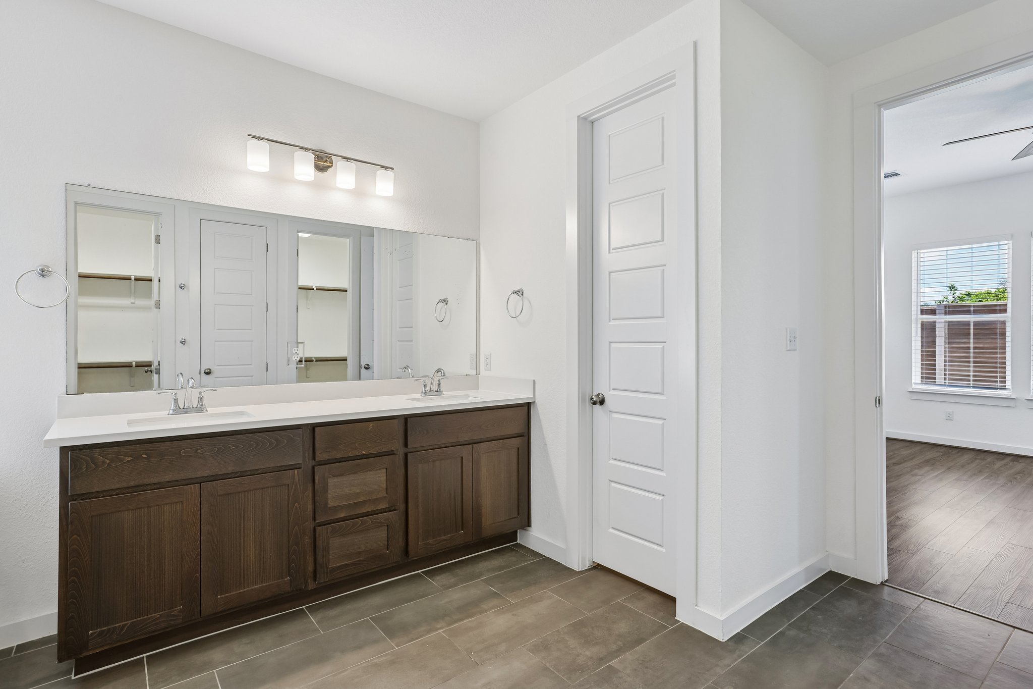 317 Independence Drive Kyle, TX 78640 - Photo 21 of 40 a spacious bathroom with a double vanity sink a large mirror and shower