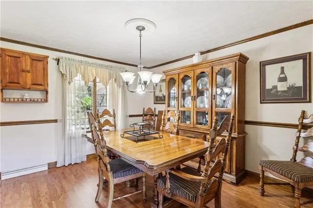 a dining room with a table chairs and kitchen view
