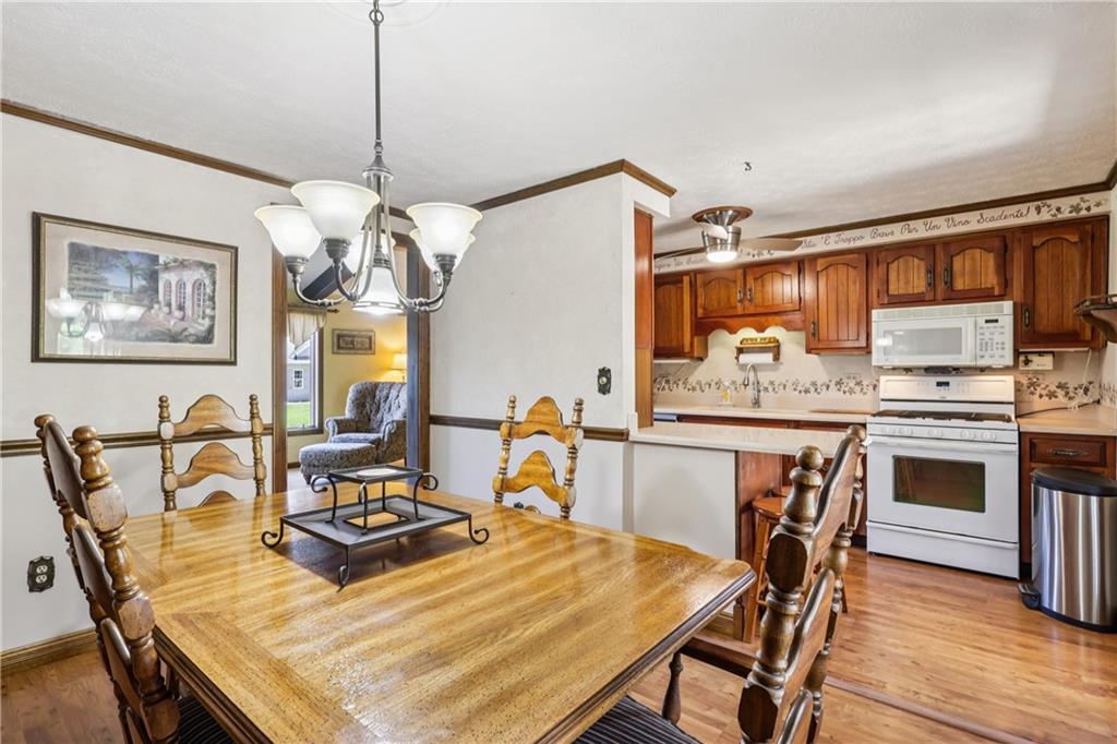 712 North 16th Street North Apollo, PA 15673 - Photo 16 of 25 a dining room with a table chairs and kitchen view