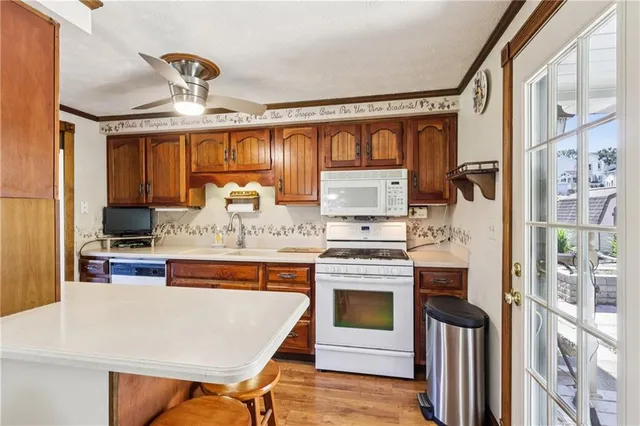 a kitchen with stainless steel appliances granite countertop a sink stove and cabinets