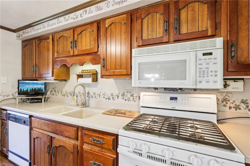 712 North 16th Street North Apollo, PA 15673 - Photo 18 of 25 a kitchen with stainless steel appliances granite countertop a sink stove and cabinets