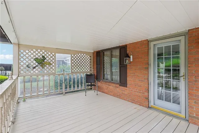 a view of outdoor space with wooden floor and windows