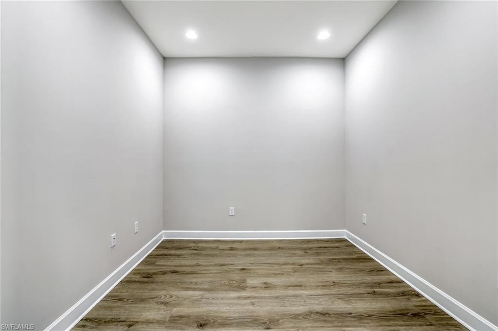 8921 Yucatan Court Naples, FL 34113 - Photo 12 of 20 a view of room with wooden floor