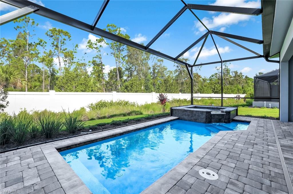 8921 Yucatan Court Naples, FL 34113 - Photo 16 of 20 a view of a swimming pool with a patio