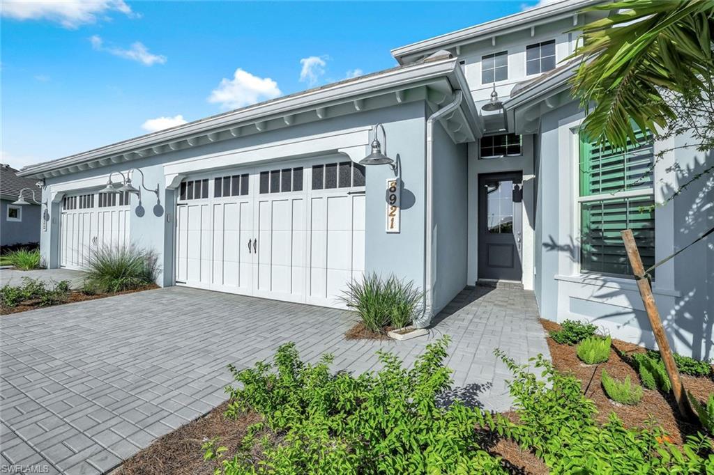 8921 Yucatan Court Naples, FL 34113 - Photo 17 of 20 a front view of a house with a yard