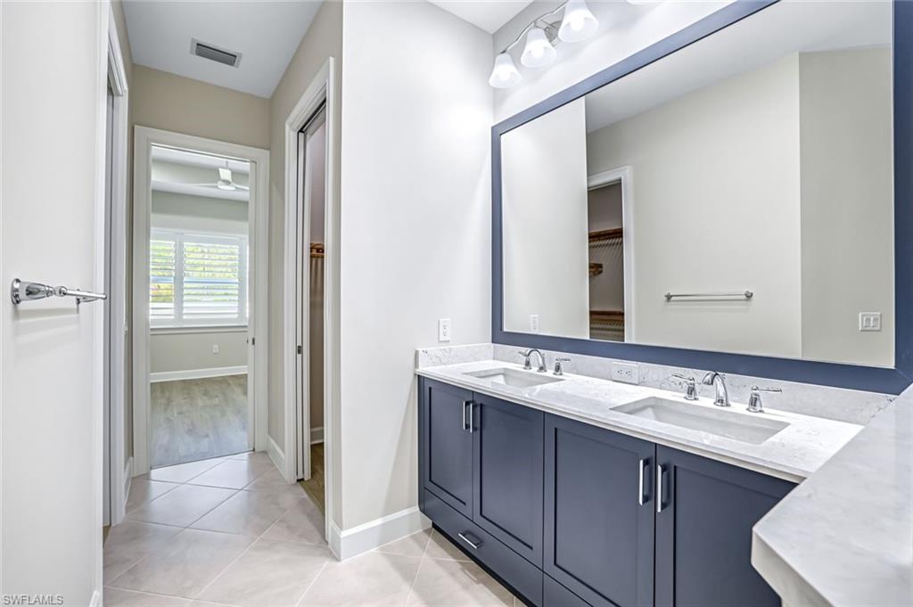 8921 Yucatan Court Naples, FL 34113 - Photo 9 of 20 a bathroom with a double vanity sink and a mirror