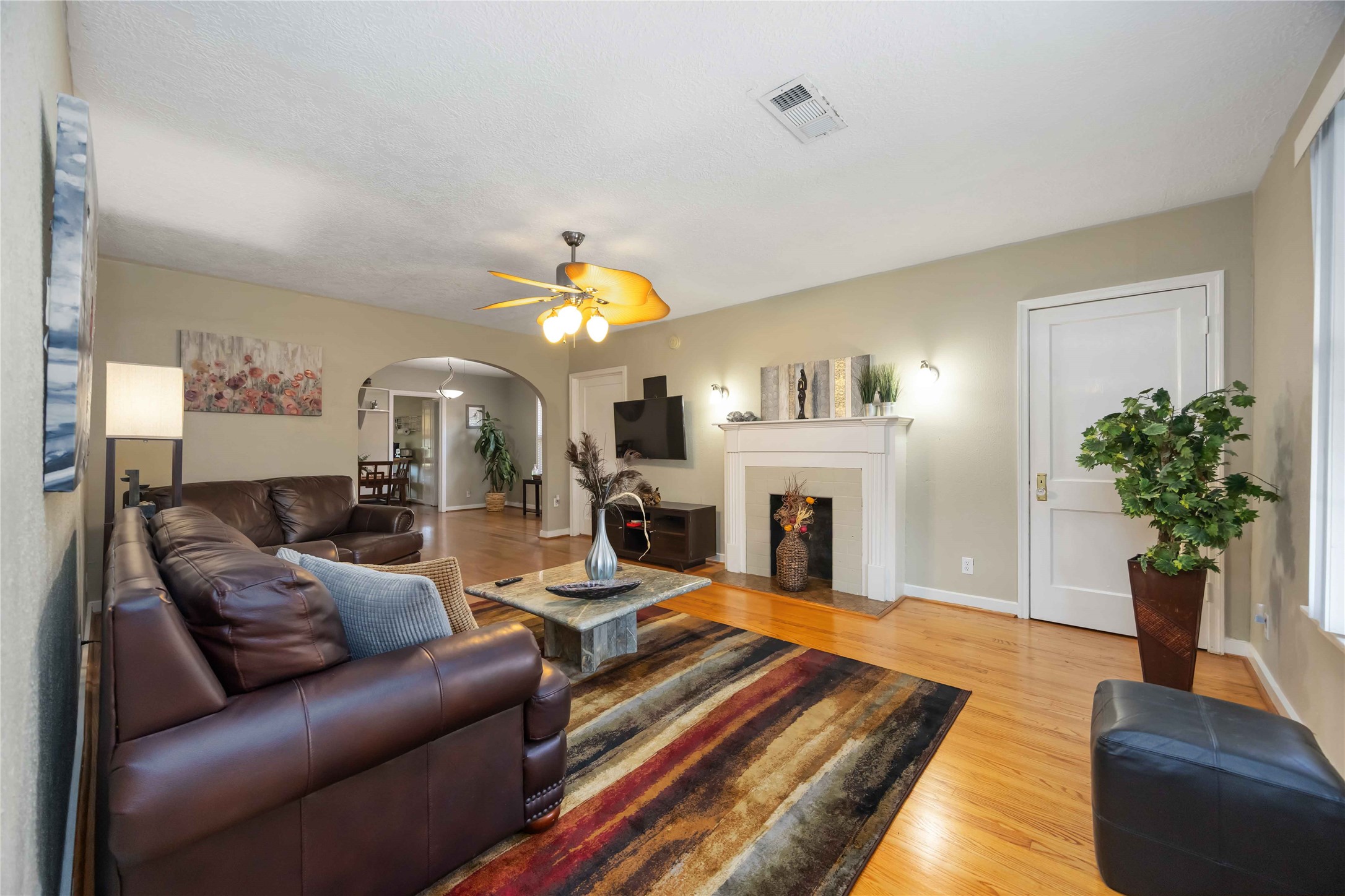 2104 Winbern Street Houston, TX 77004 - Photo 11 of 24 a living room with furniture fireplace and a potted plant