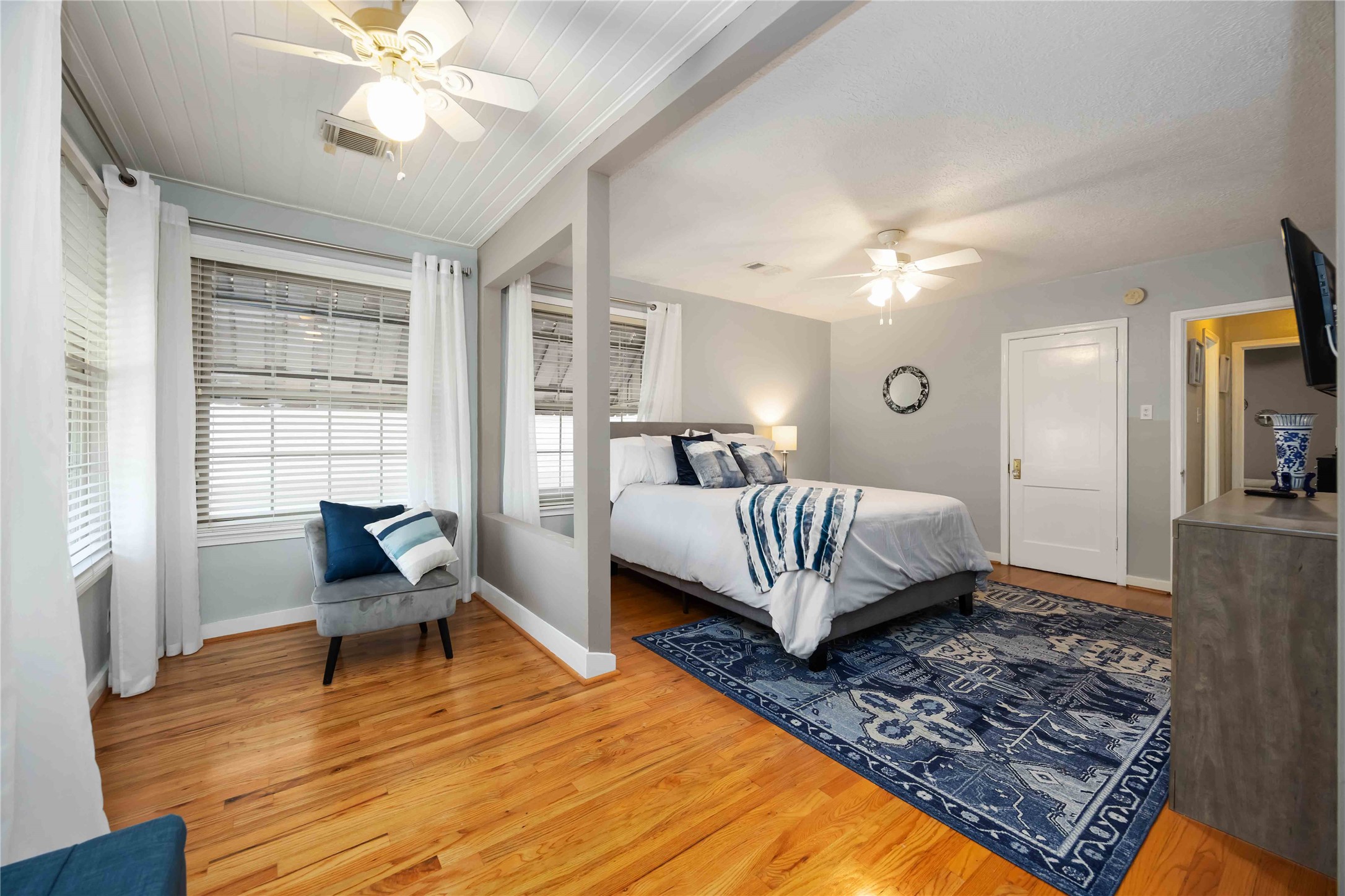 2104 Winbern Street Houston, TX 77004 - Photo 13 of 24 a bedroom with a bed and wooden floor