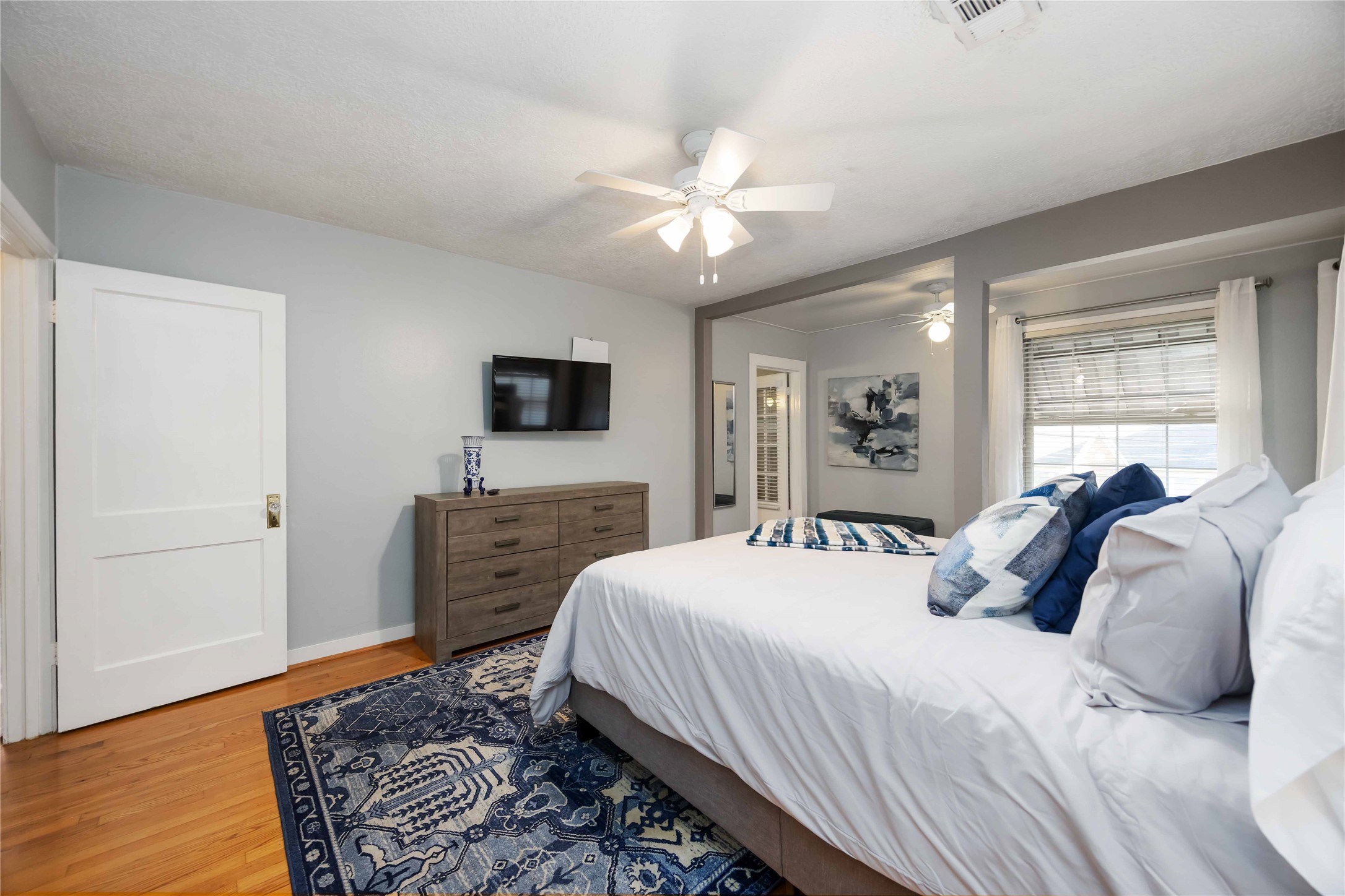 2104 Winbern Street Houston, TX 77004 - Photo 15 of 24 a bedroom with a bed and a chandelier