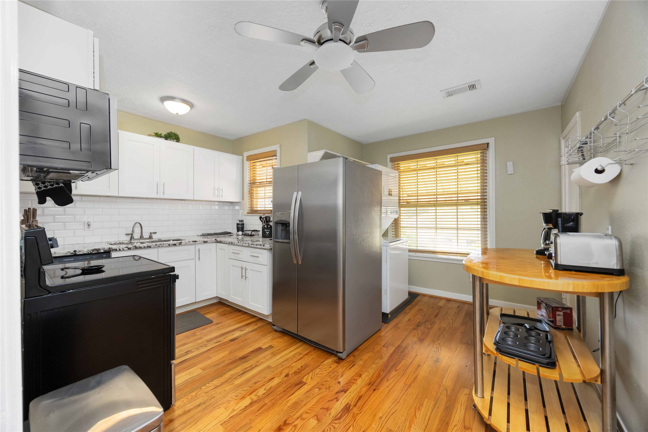 2104 Winbern Street Houston, TX 77004 - Photo 20 of 24 a kitchen with stainless steel appliances granite countertop a sink stove and refrigerator