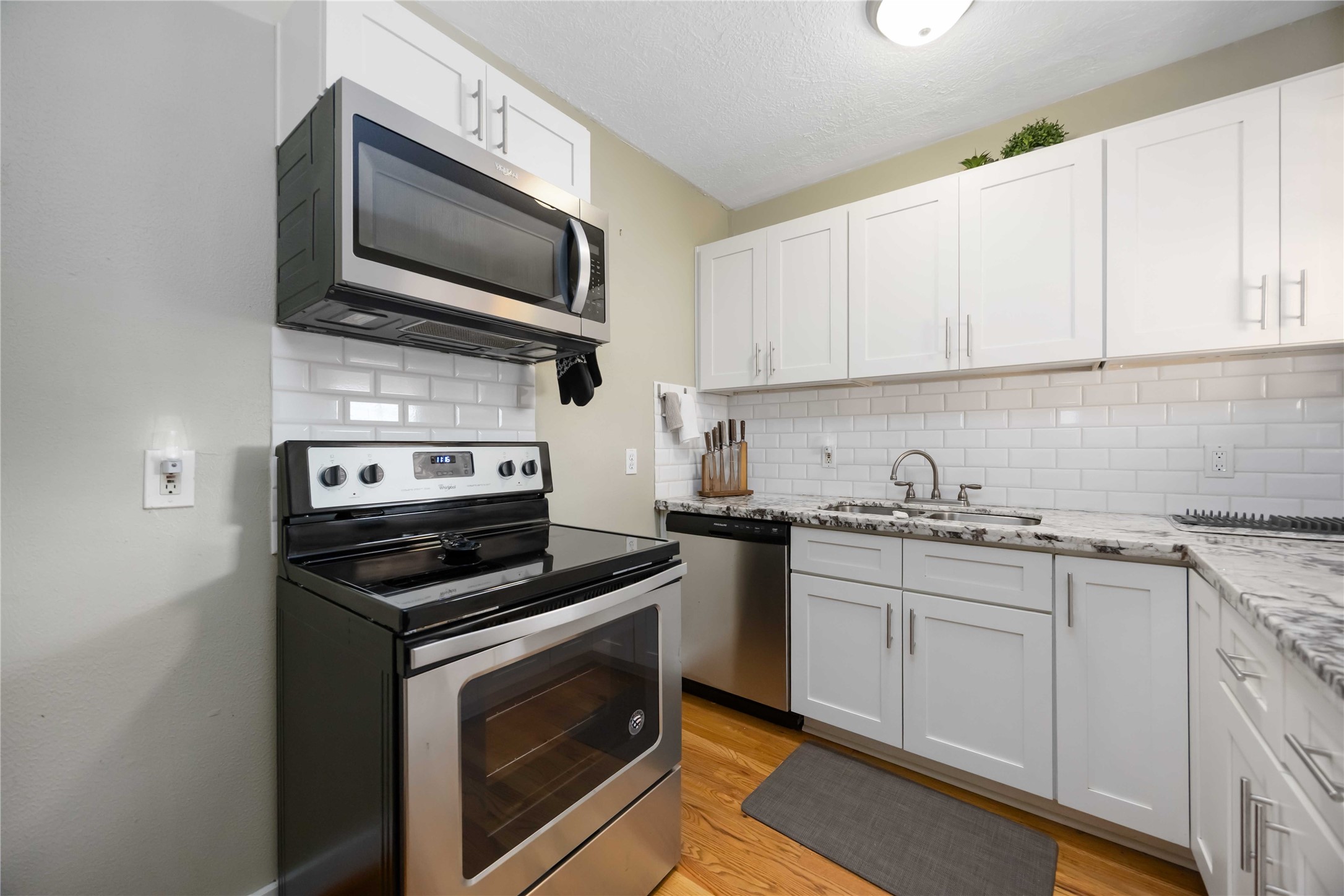 2104 Winbern Street Houston, TX 77004 - Photo 22 of 24 a kitchen with a sink stove and microwave