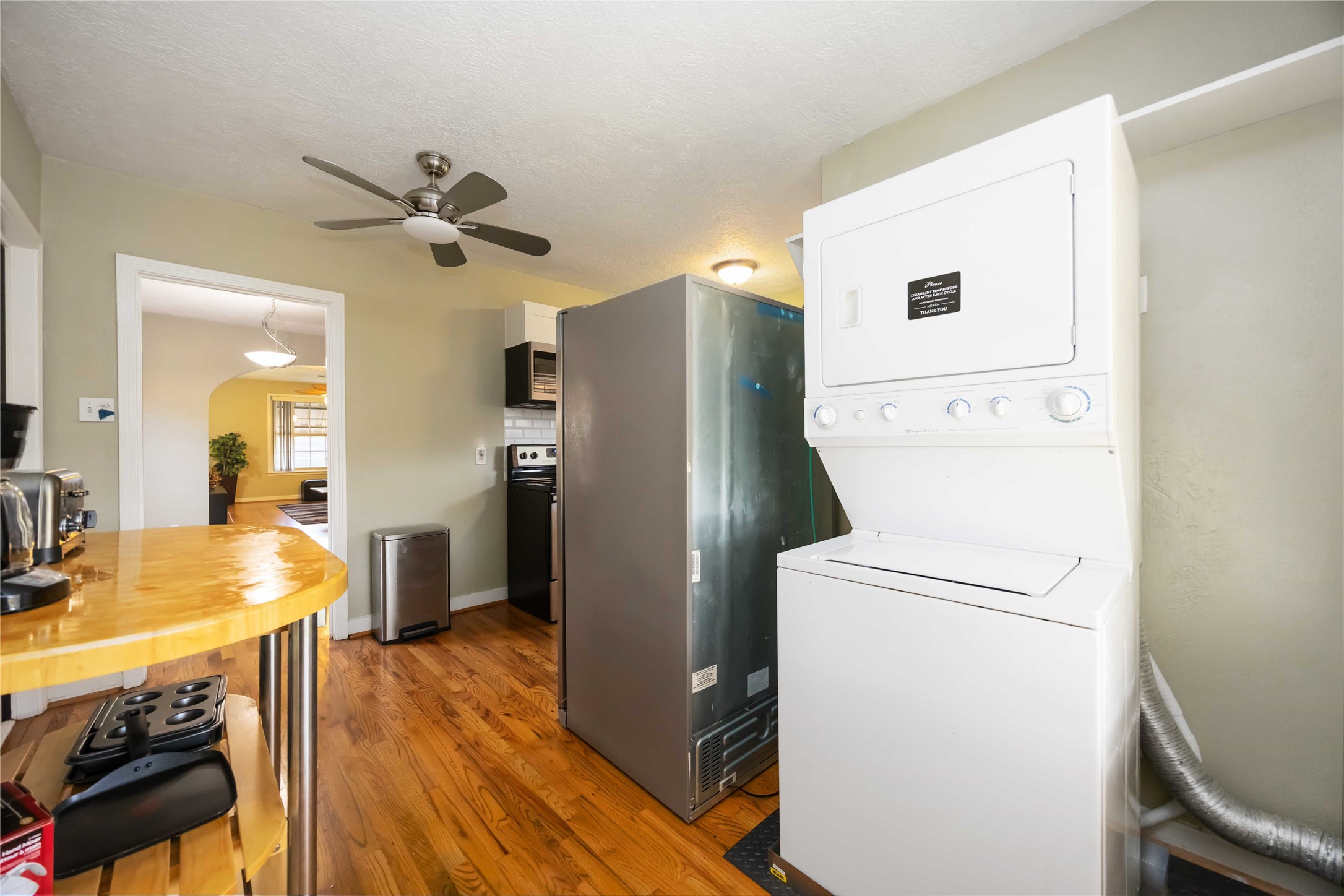 2104 Winbern Street Houston, TX 77004 - Photo 23 of 24 a view of a kitchen with fridge and wooden floor