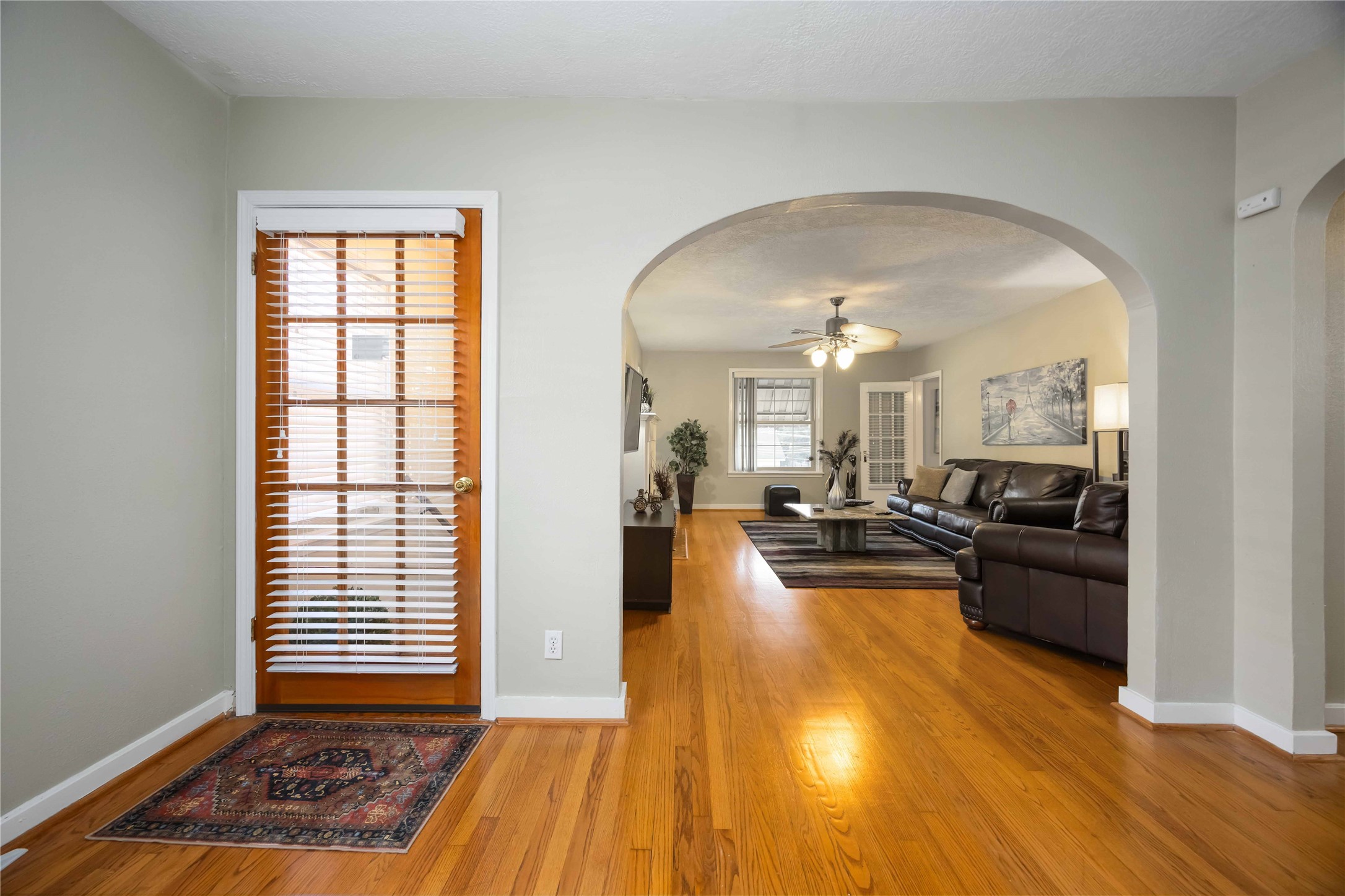 2104 Winbern Street Houston, TX 77004 - Photo 8 of 24 a view of a living room and kitchen with wooden floor