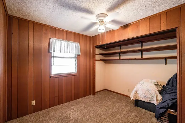 a view of a room with gym equipment and chandelier