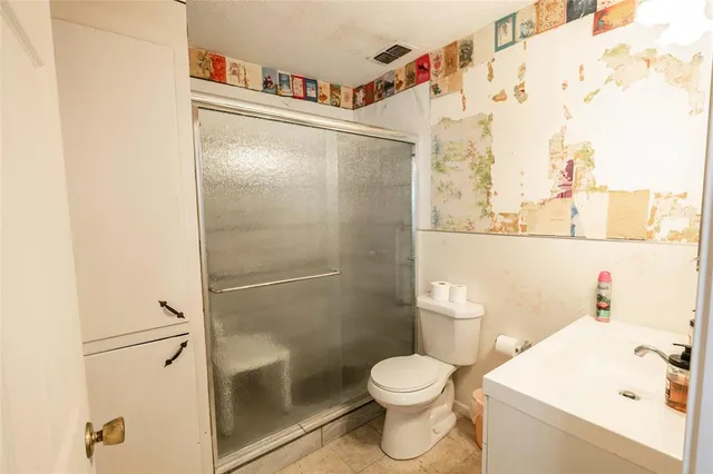 a white toilet sitting next to a bathroom sink