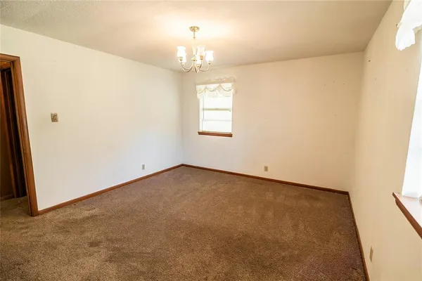 an empty room with a chandelier