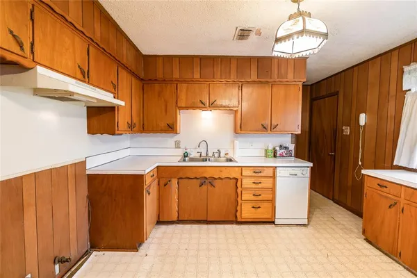 a kitchen with stainless steel appliances a stove a refrigerator and chandelier
