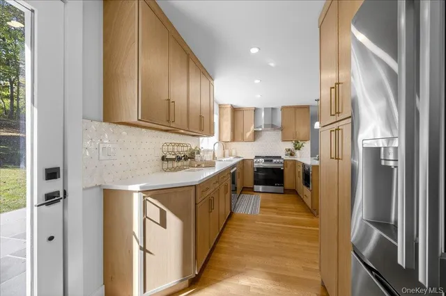 a kitchen with cabinets and a refrigerator