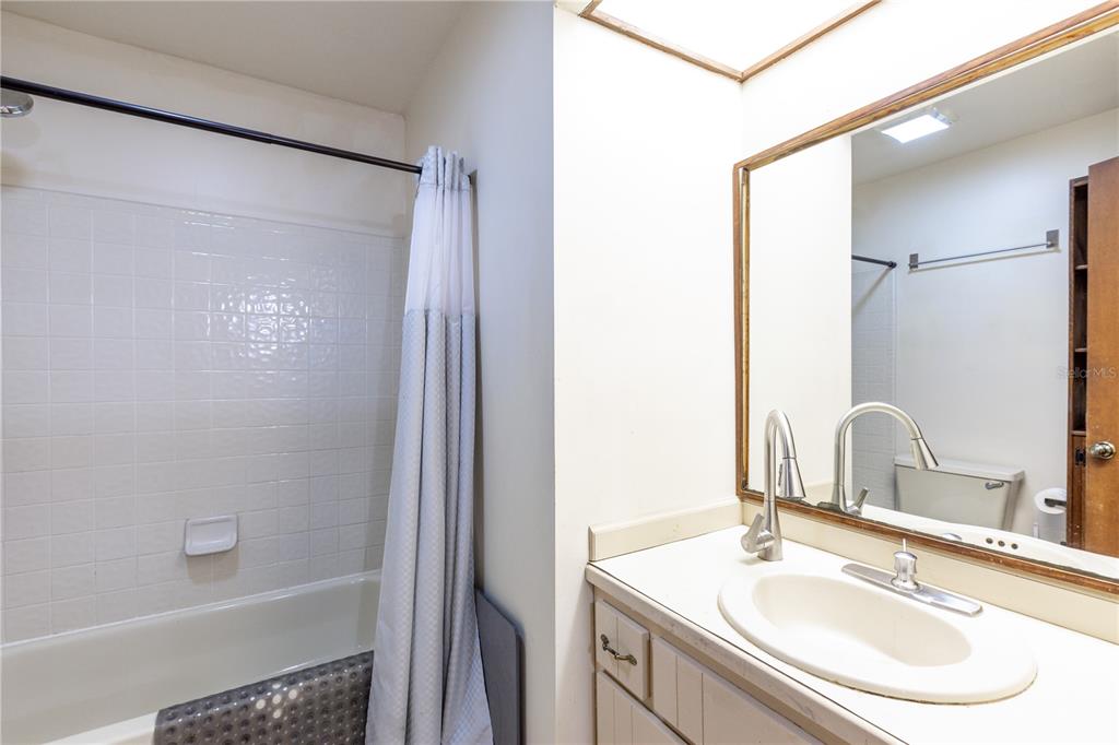5208 Southwest 86 Terrace Gainesville, FL 32608 - Photo 18 of 26 a bathroom with a sink and a mirror