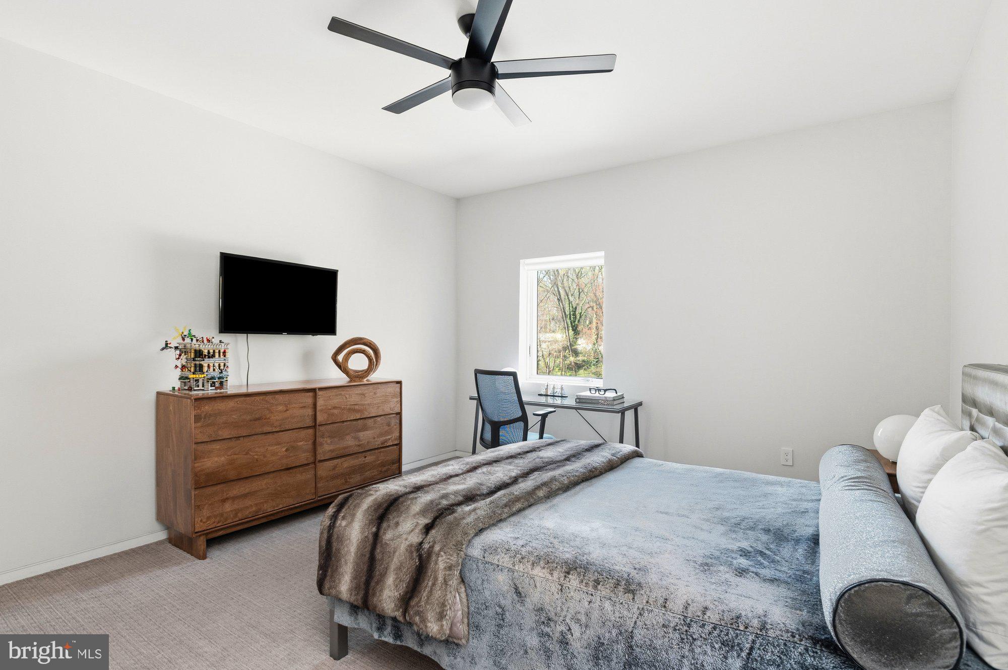 6016 Chesterbrook Road McLean, VA 22101 - Photo 22 of 67 a bedroom with a bed and a flat screen tv