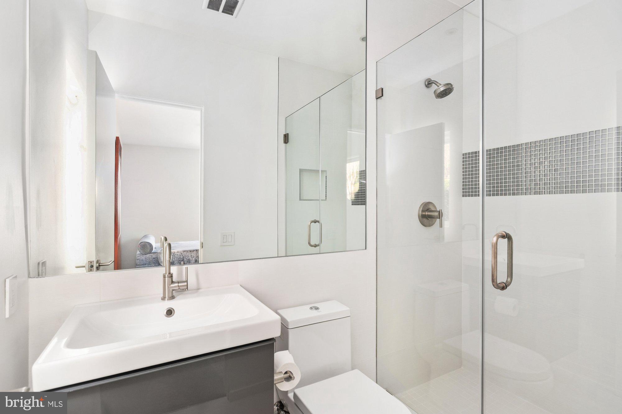 6016 Chesterbrook Road McLean, VA 22101 - Photo 23 of 67 a bathroom with a sink toilet and shower