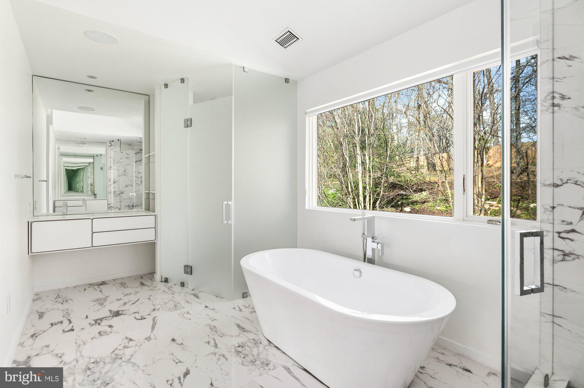 6016 Chesterbrook Road McLean, VA 22101 - Photo 34 of 67 a white bath tub sitting in a bathroom next to a window