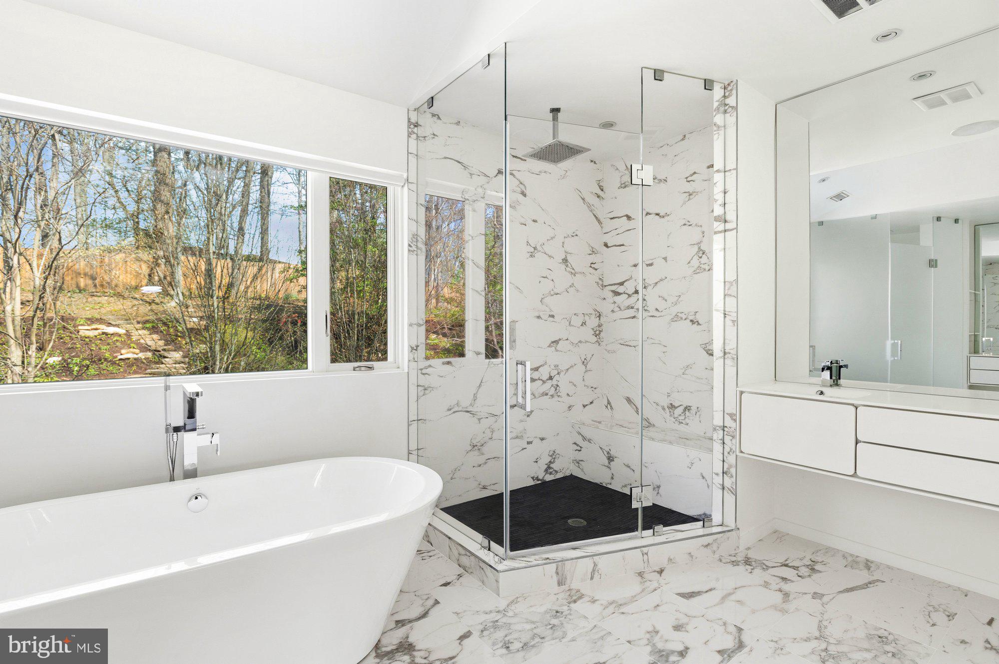 6016 Chesterbrook Road McLean, VA 22101 - Photo 35 of 67 a bathroom with a bathtub sink and shower