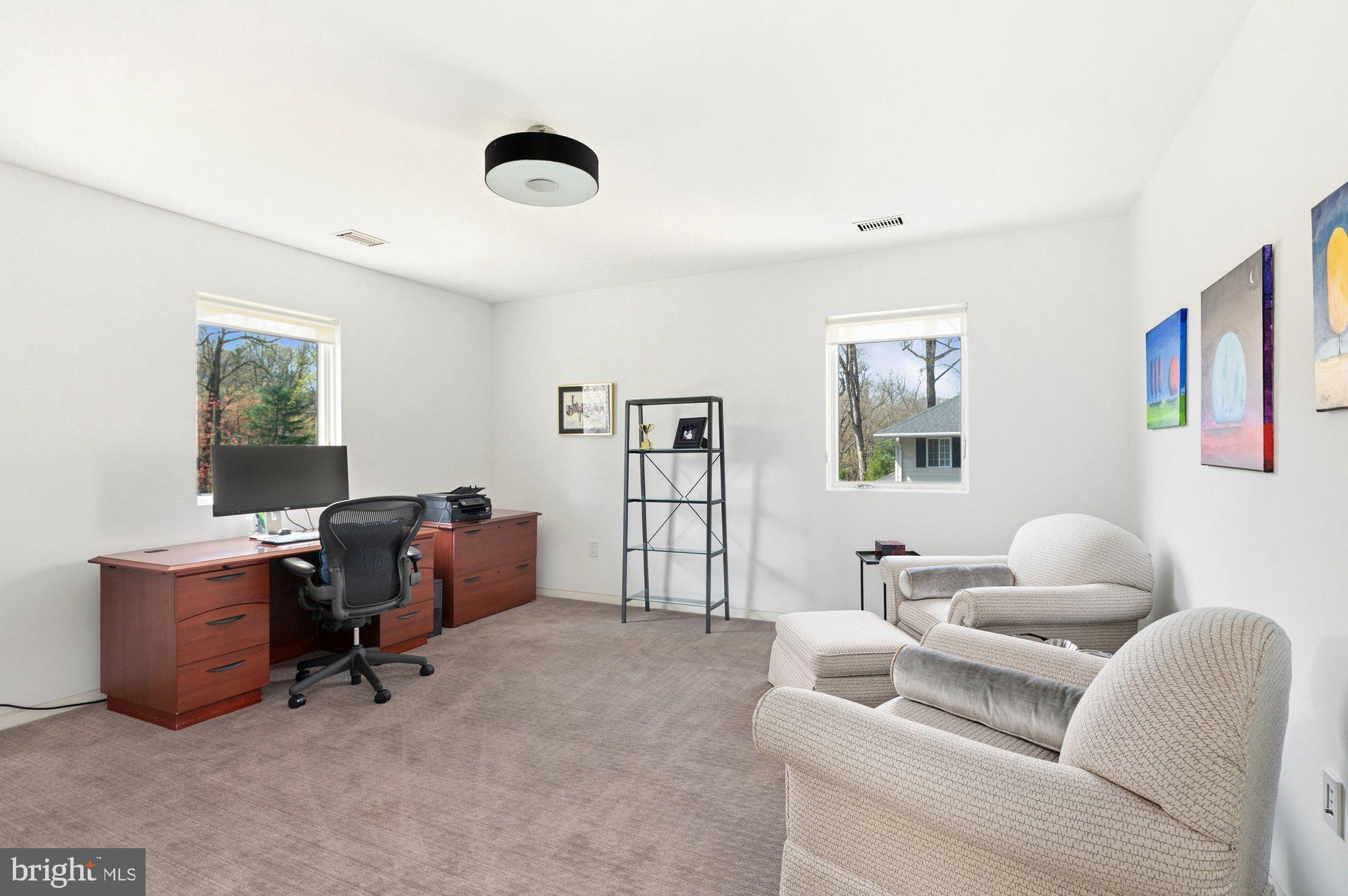6016 Chesterbrook Road McLean, VA 22101 - Photo 38 of 67 a livingroom with workspace and a couch