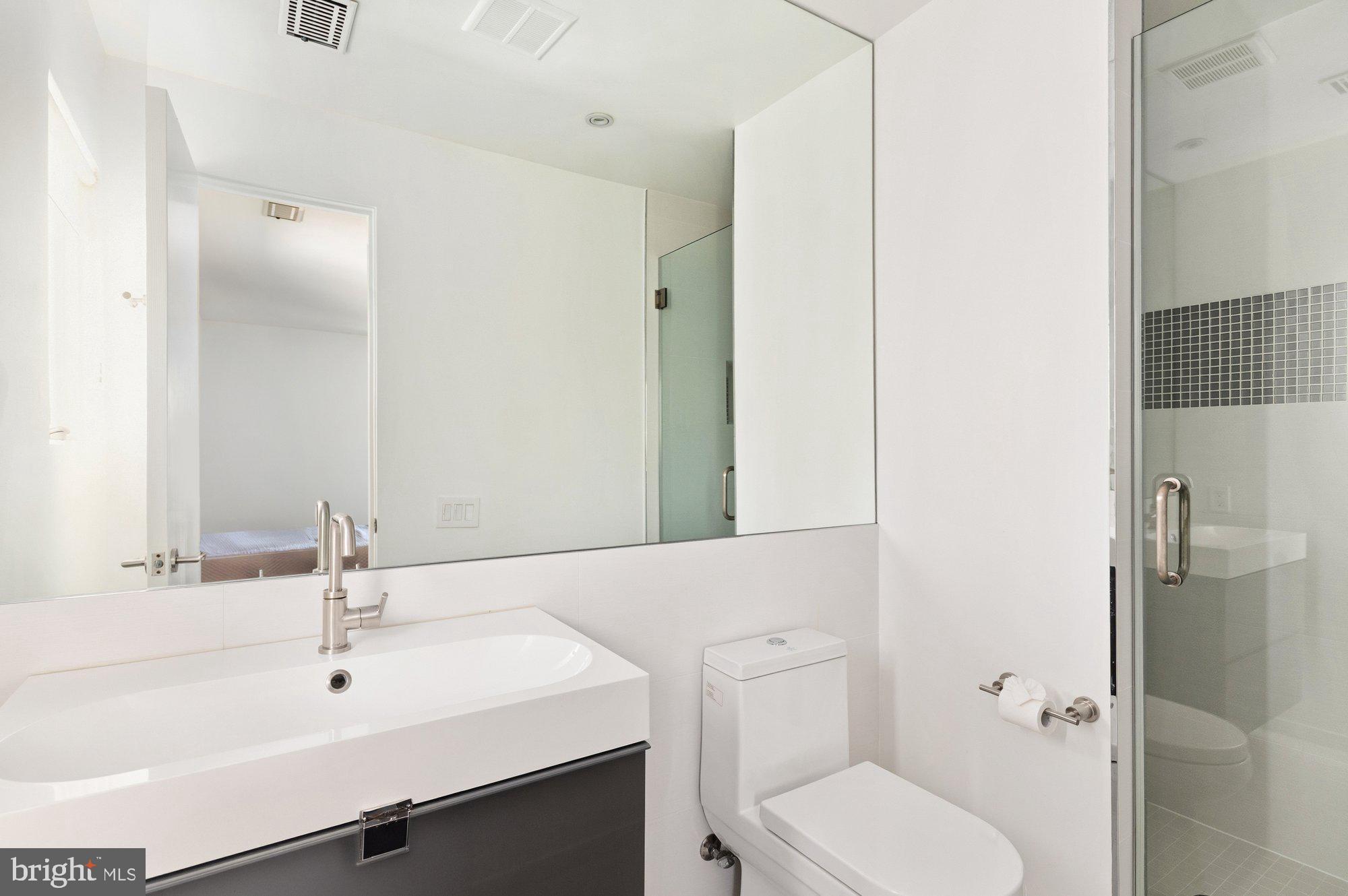 6016 Chesterbrook Road McLean, VA 22101 - Photo 43 of 67 a bathroom with a sink toilet and shower