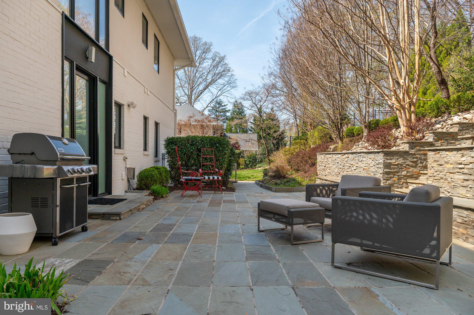 6016 Chesterbrook Road McLean, VA 22101 - Photo 53 of 67 a view of a patio with couches and a fire pit and wooden fence