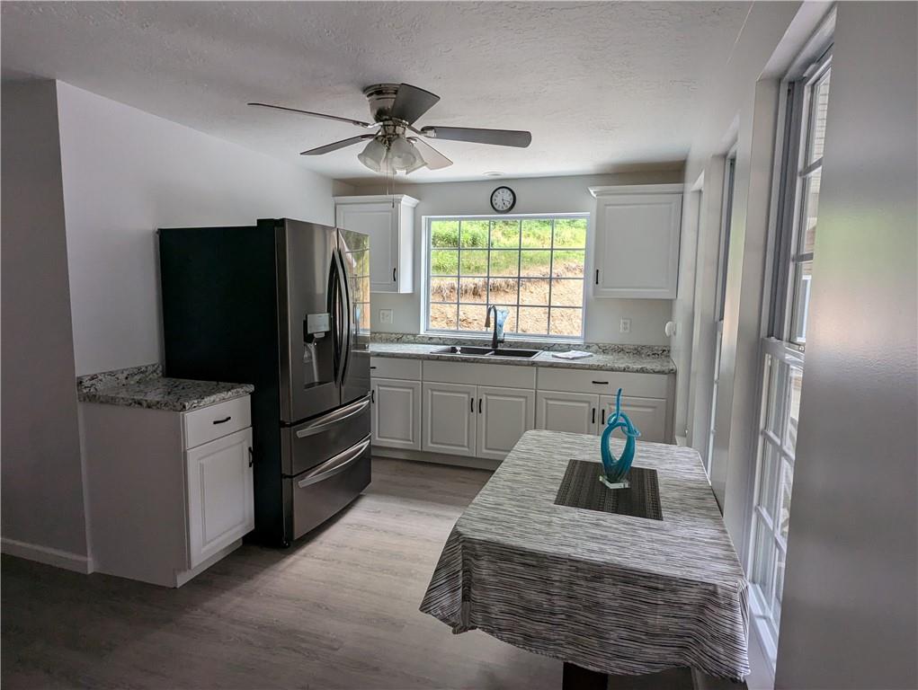 362 Palmer Road Butler, PA 16001 - Photo 8 of 32 a kitchen with a refrigerator and a sink