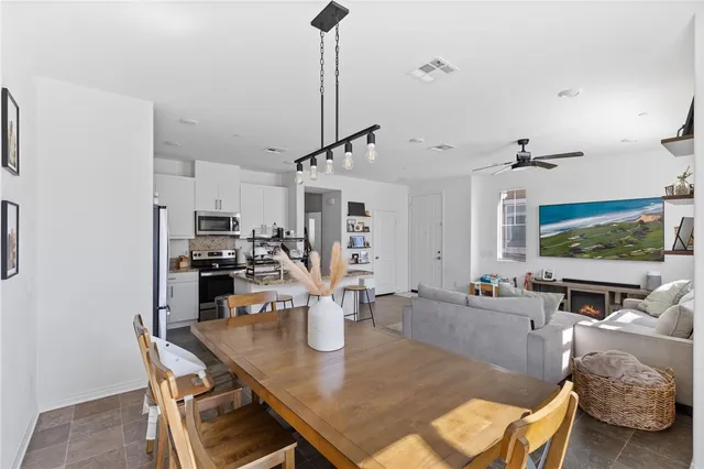a living room with patio furniture and a potted plant