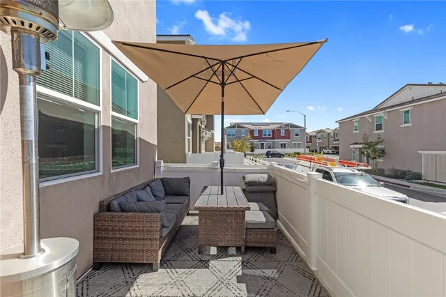 a view of a balcony with table and chairs
