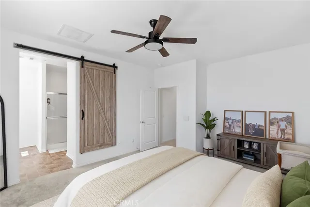 a bedroom with a bed and a large mirror