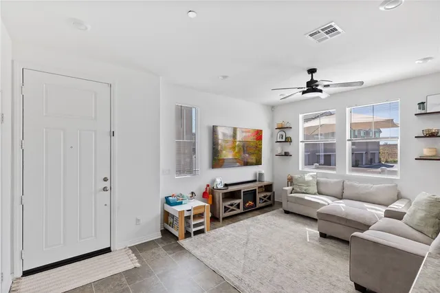 a living room with furniture and kitchen view