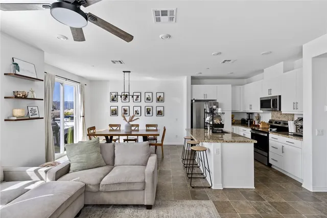 a kitchen with stainless steel appliances kitchen island granite countertop a refrigerator and a stove