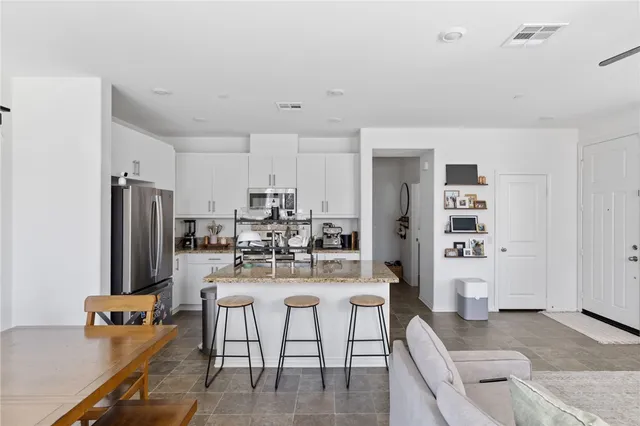 a kitchen with a refrigerator a stove and a sink
