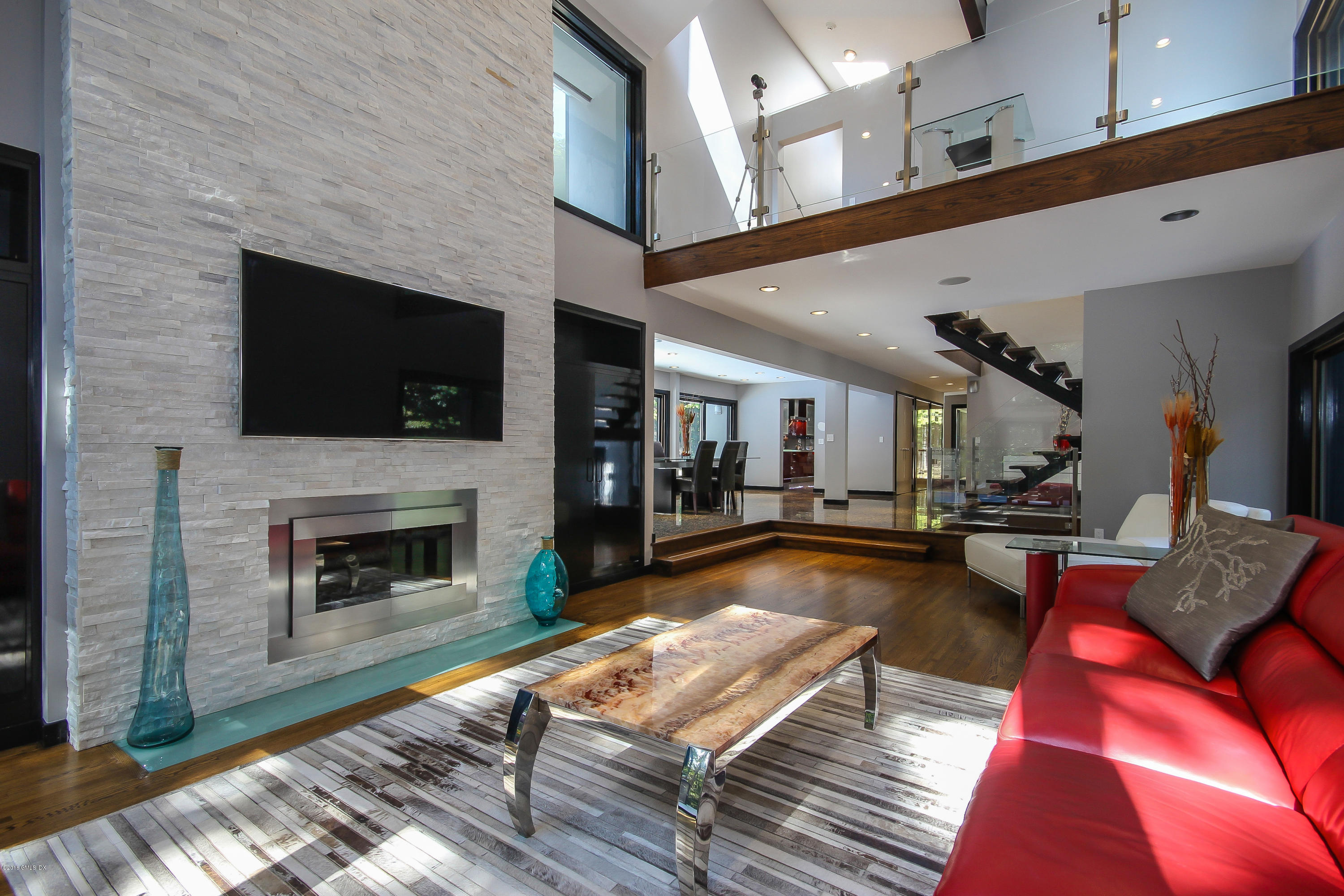 106 Porchuck Road Greenwich, CT 06831 - Photo 1 of 37 a living room with furniture a flat screen tv and a fireplace