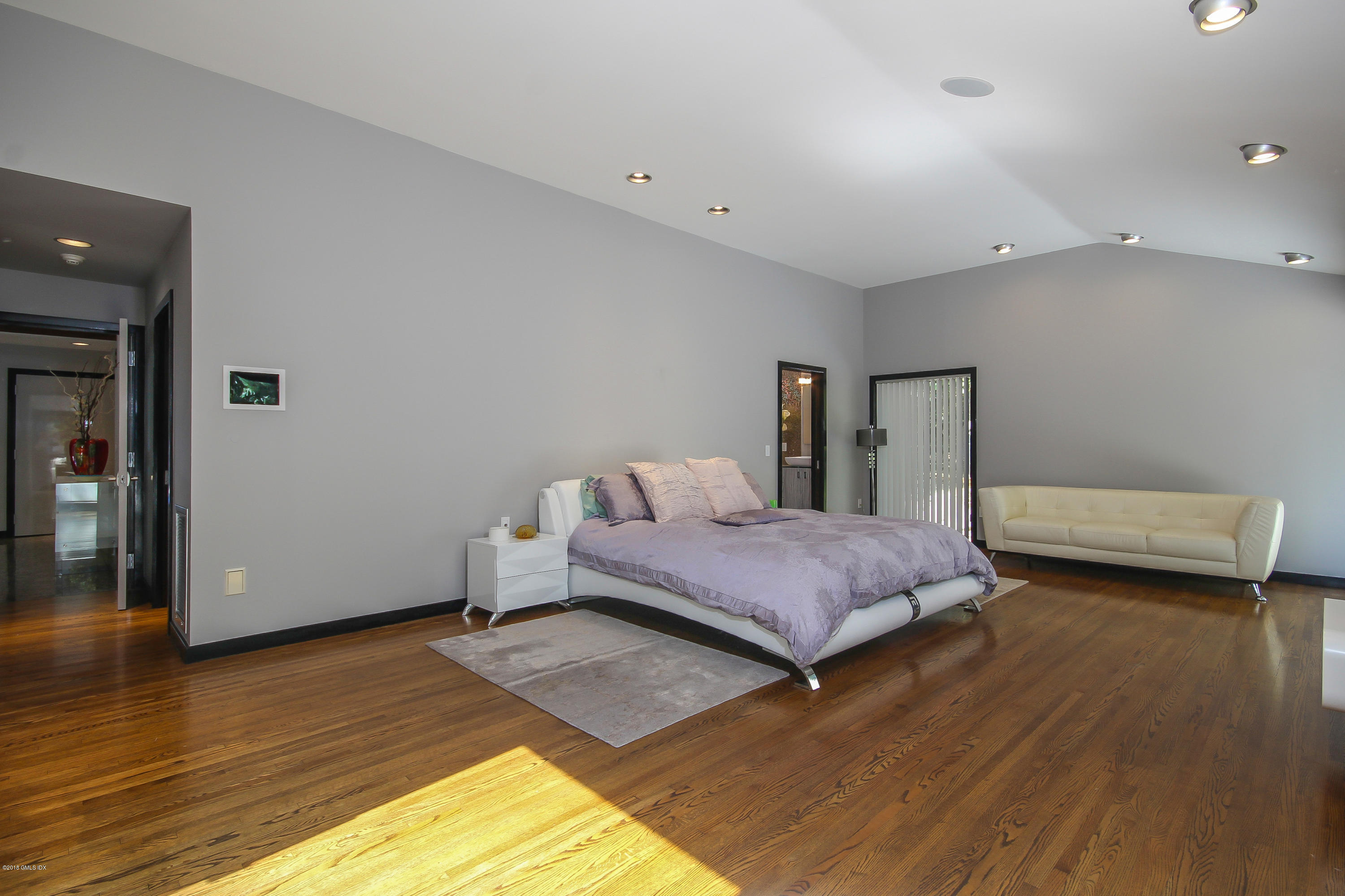 106 Porchuck Road Greenwich, CT 06831 - Photo 11 of 37 a bedroom with a bed and wooden floor