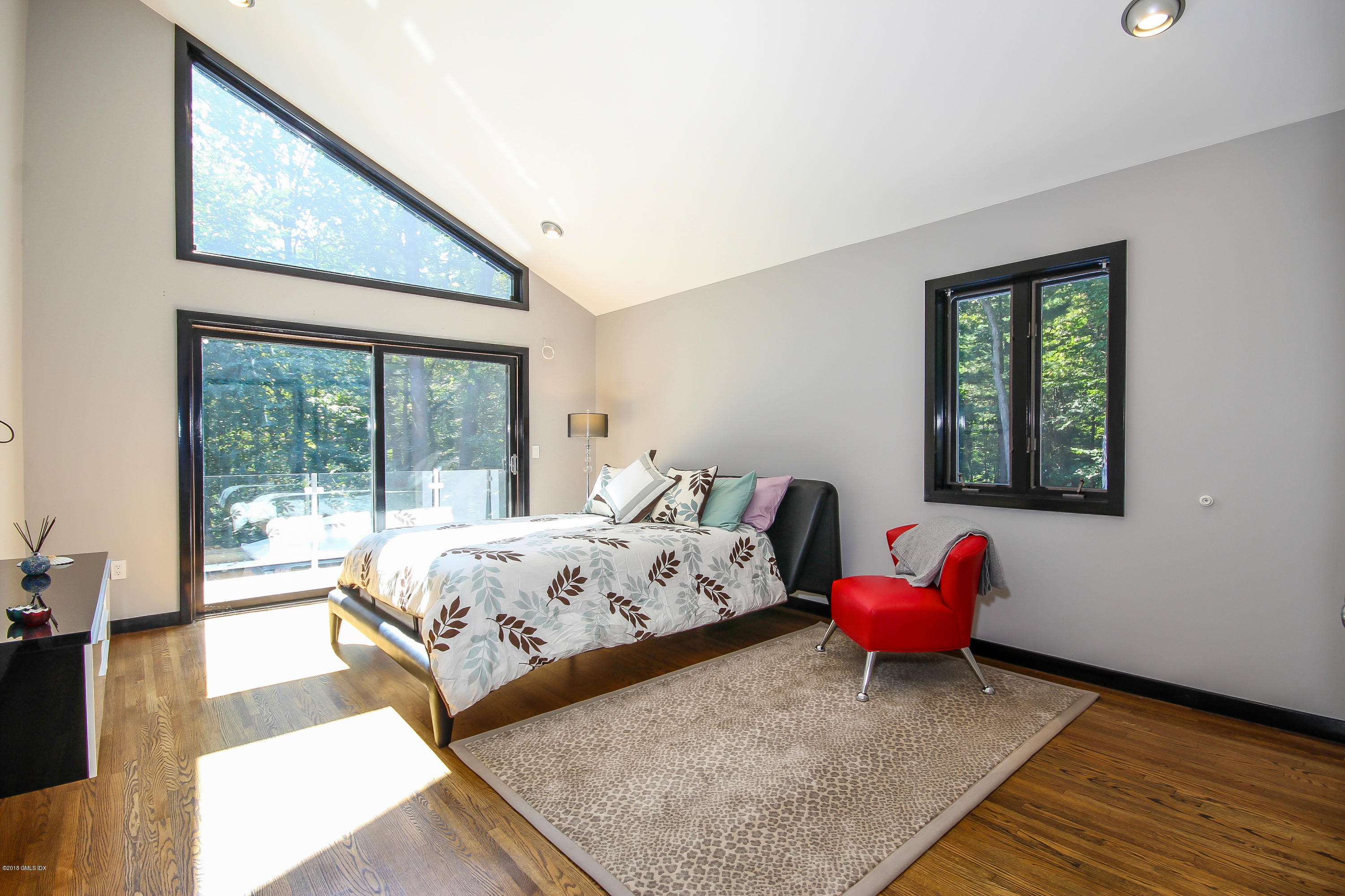 106 Porchuck Road Greenwich, CT 06831 - Photo 17 of 37 a bed room with a bed and a chair