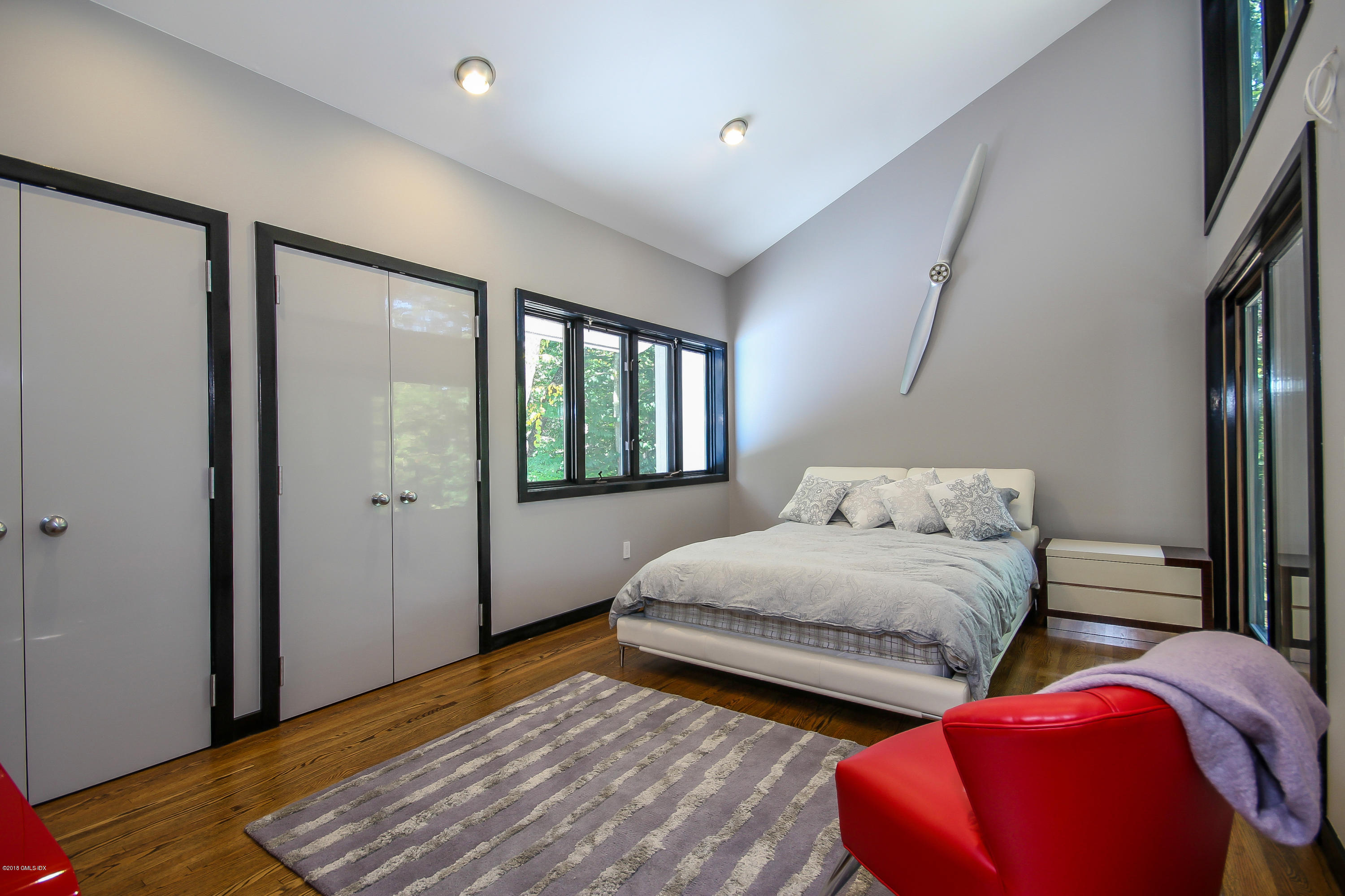 106 Porchuck Road Greenwich, CT 06831 - Photo 20 of 37 a bedroom with two beds and a potted plant