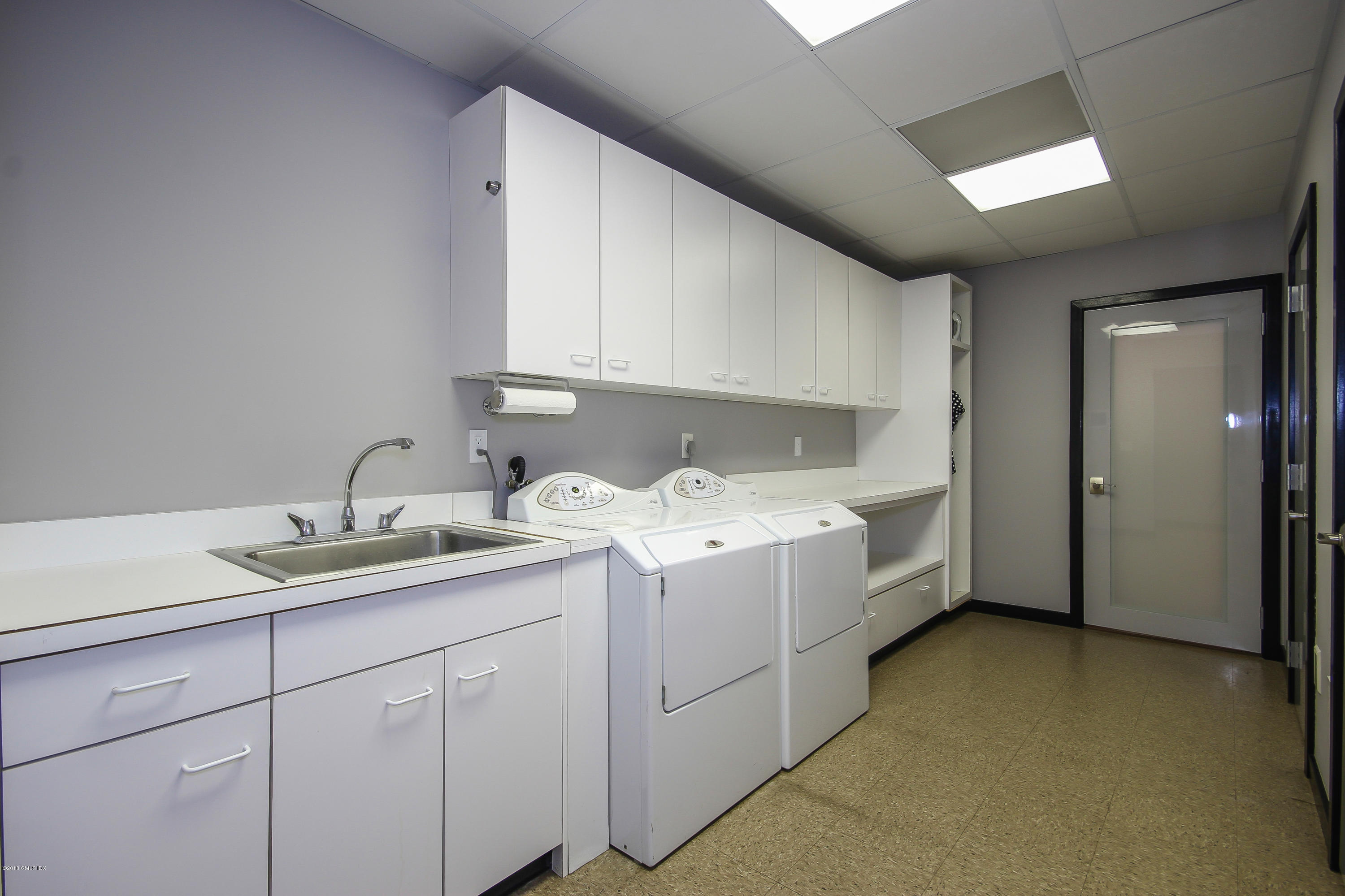 106 Porchuck Road Greenwich, CT 06831 - Photo 28 of 37 a utility room with a sink a washer and dryer