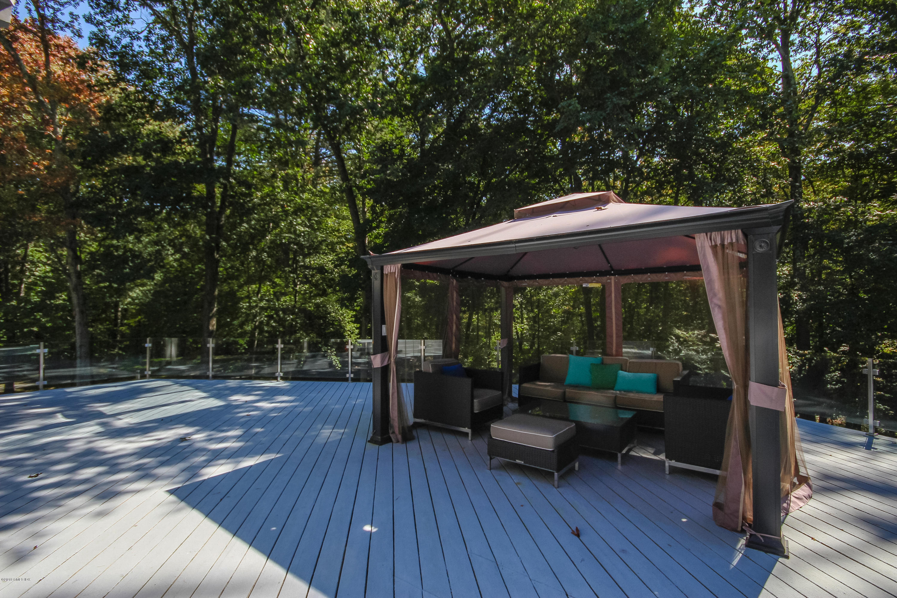 106 Porchuck Road Greenwich, CT 06831 - Photo 30 of 37 a backyard of a house with wooden floor yard barbeque oven and outdoor seating